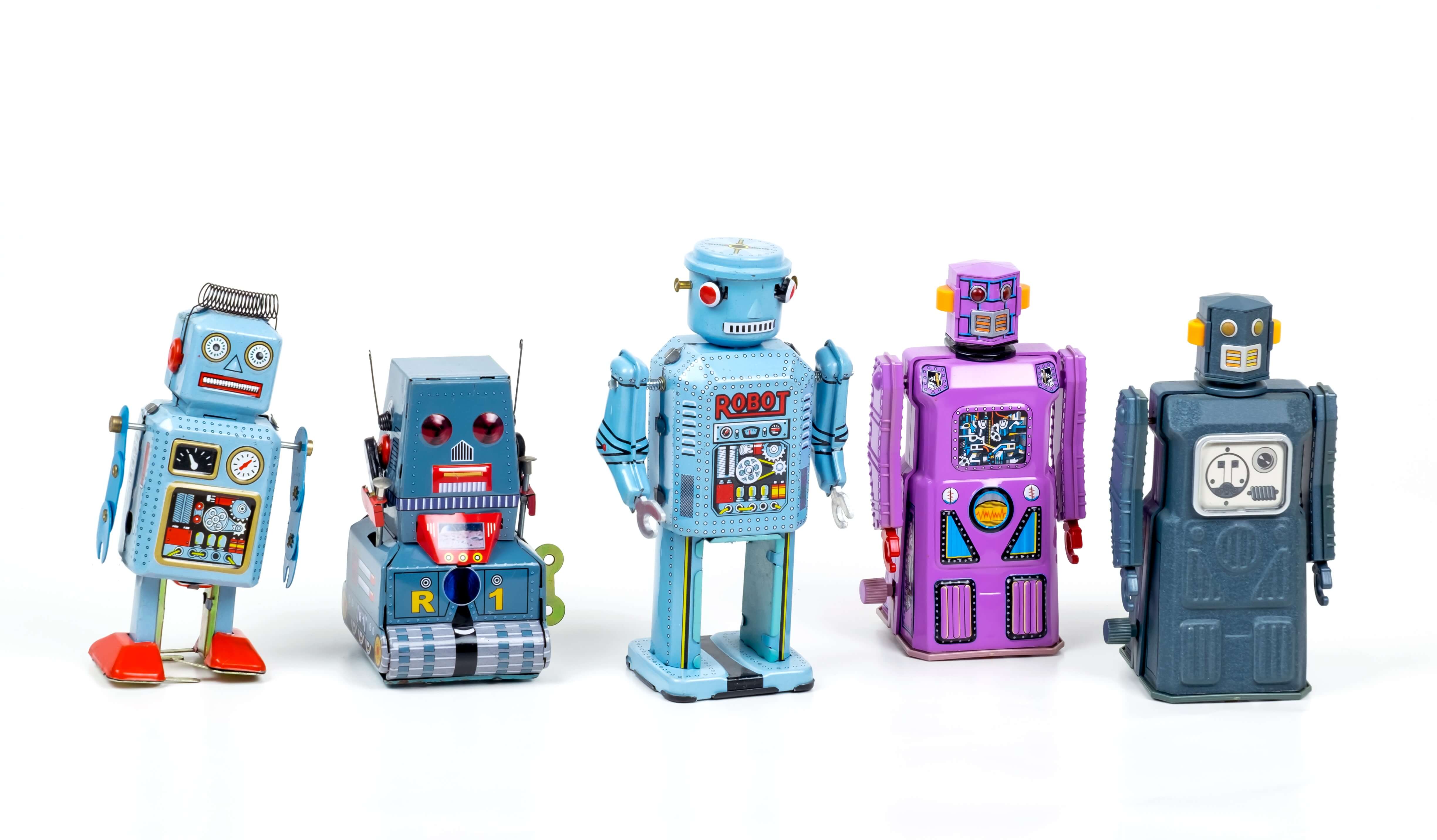 5 toy mechanical robots standing in a row