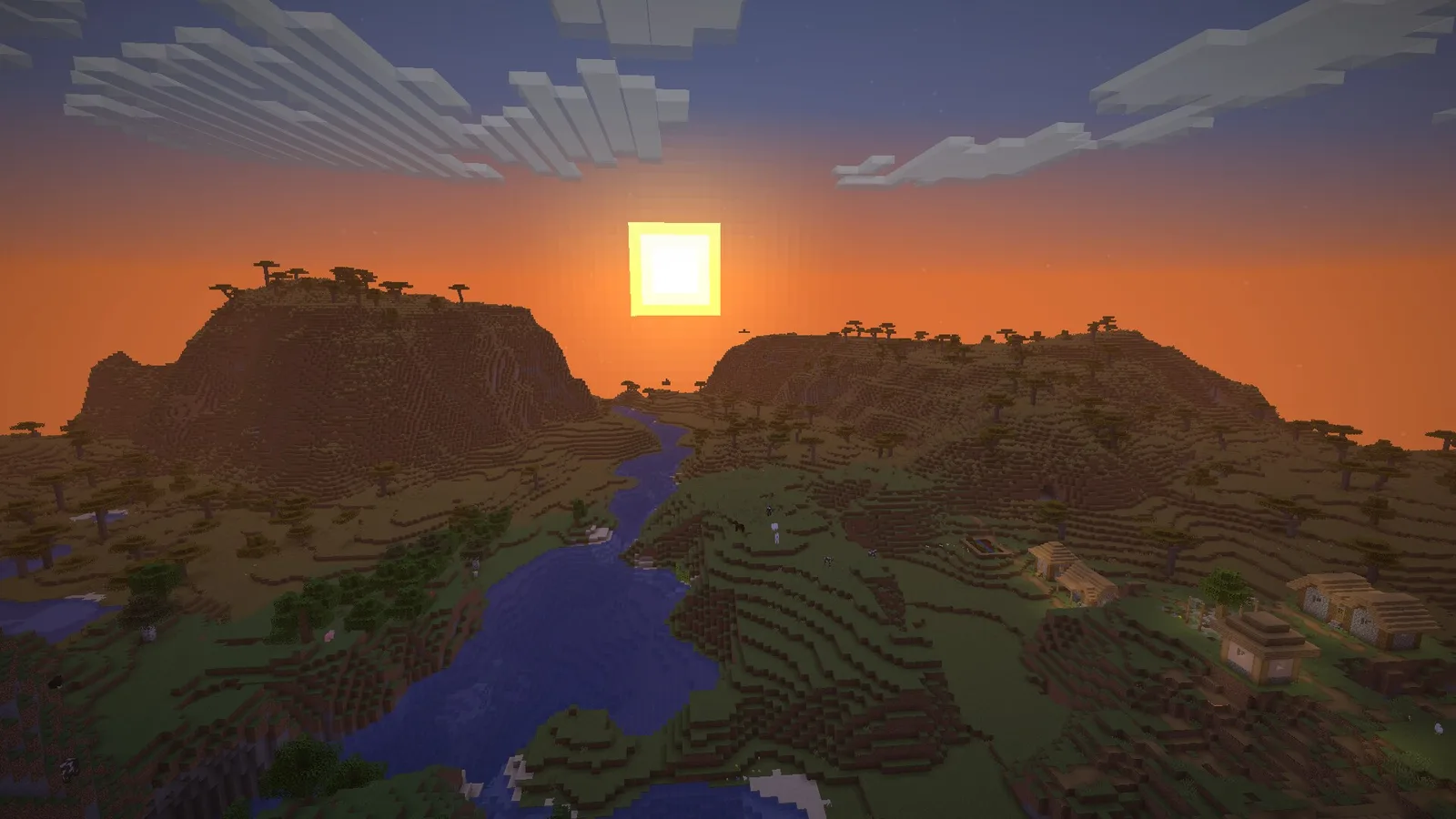 Sunset over a savanna river valley and a plains village