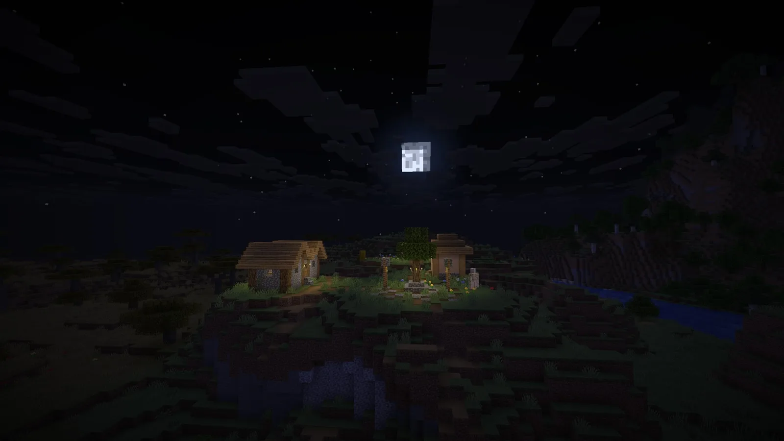 Moonrise over a torch-lit village and river