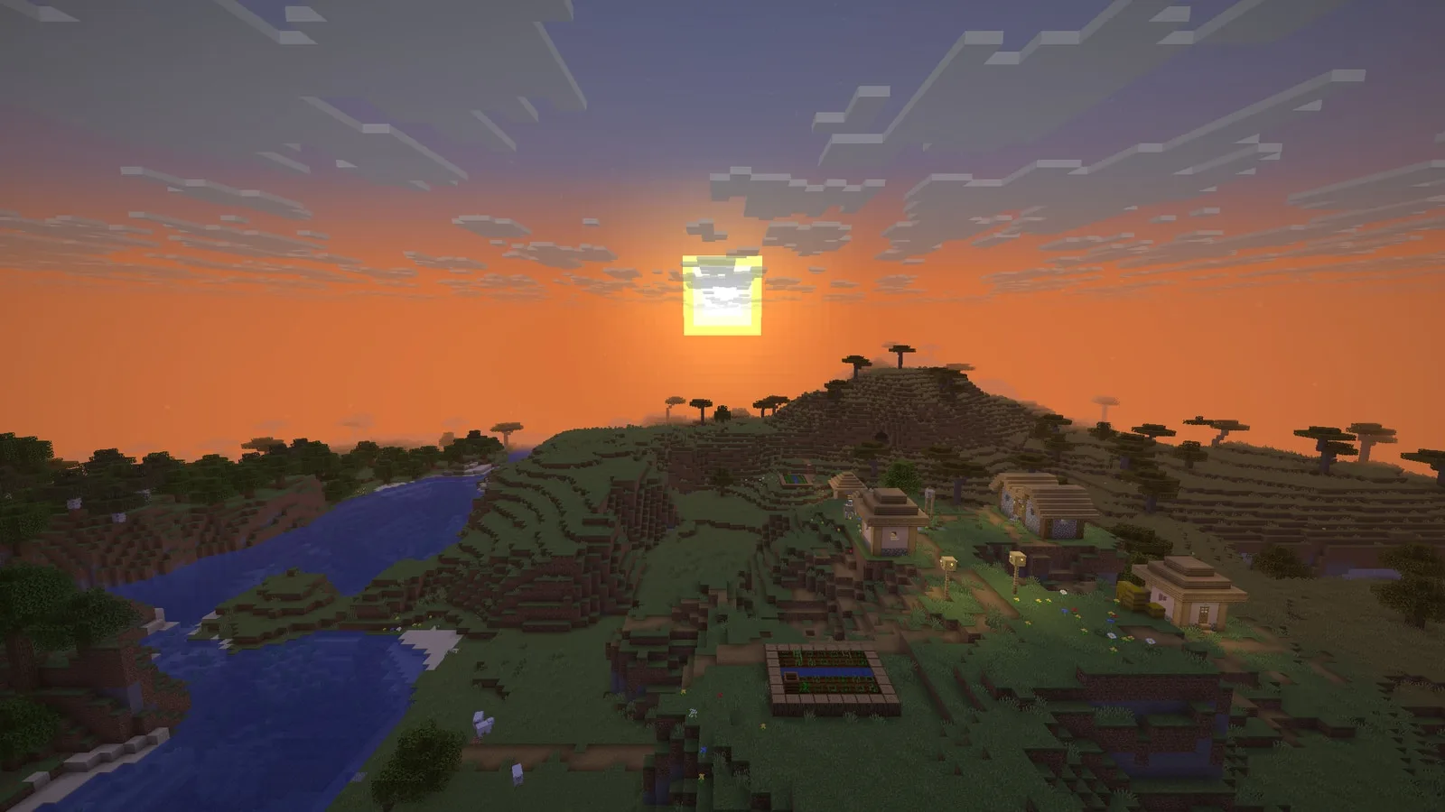 Sunset over a savanna river valley and a plains village