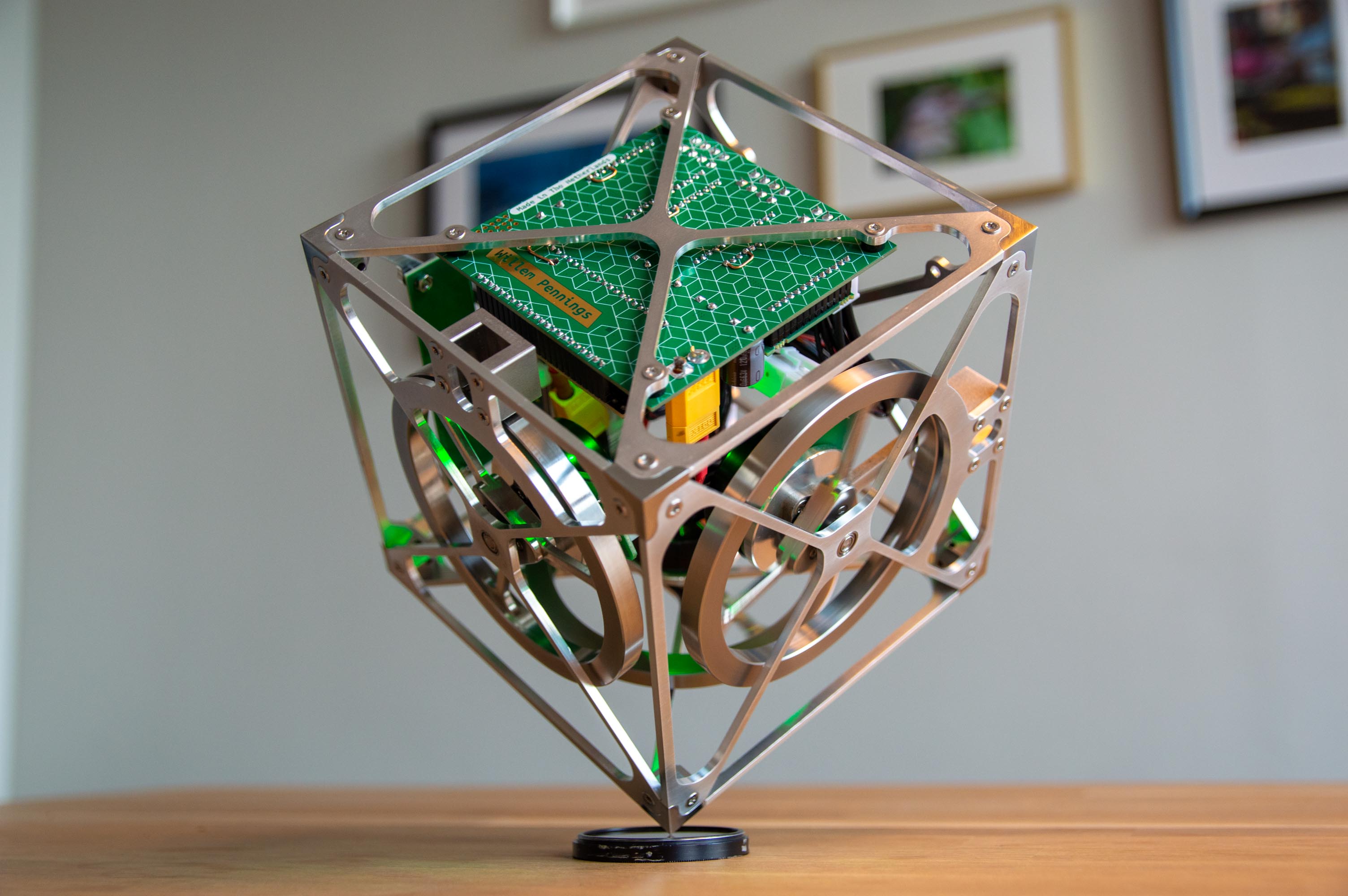 The cube balances on its corner using three integrated reaction wheels