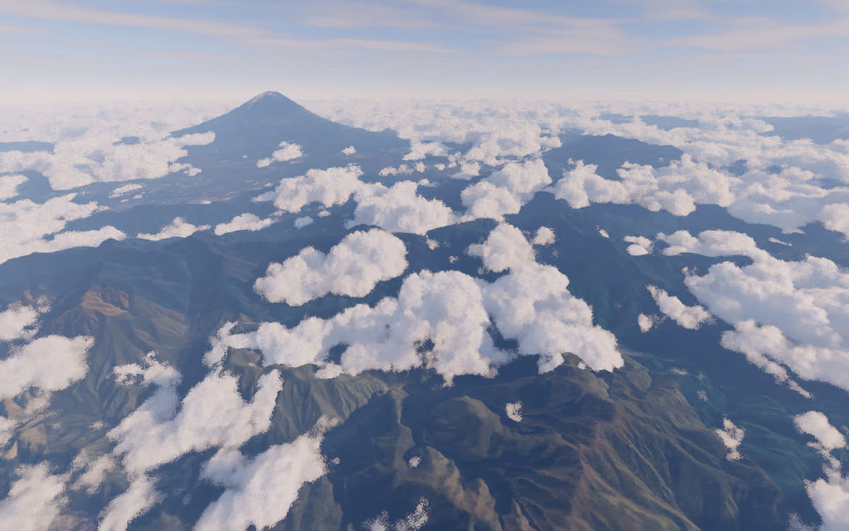 Clouds drifting over mountain terrain