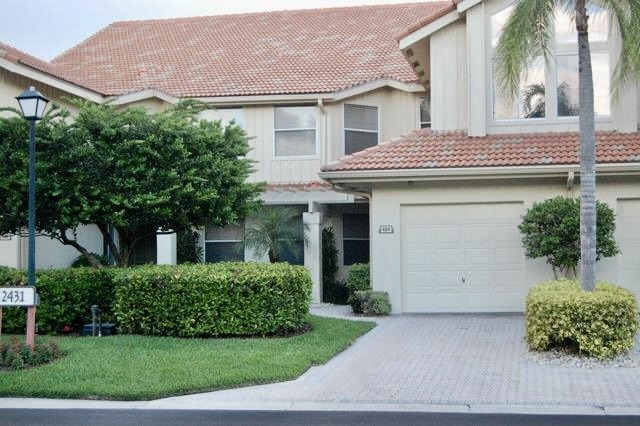 Building exterior with red tile roof and palm trees