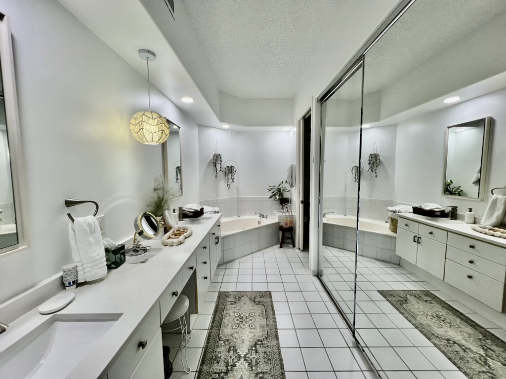 Primary bathroom with jacuzzi tub and double vanity