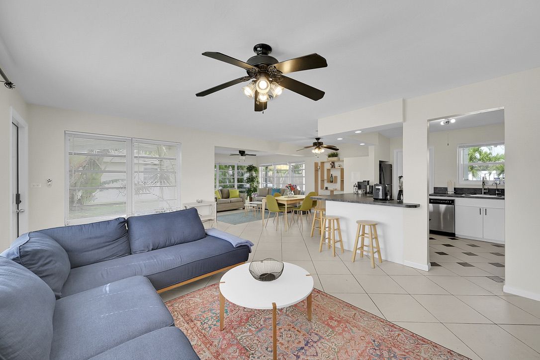 Open living room and kitchen with island and stools