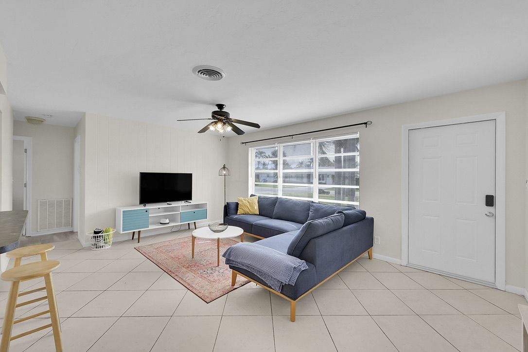 Living room with blue sectional sofa and TV