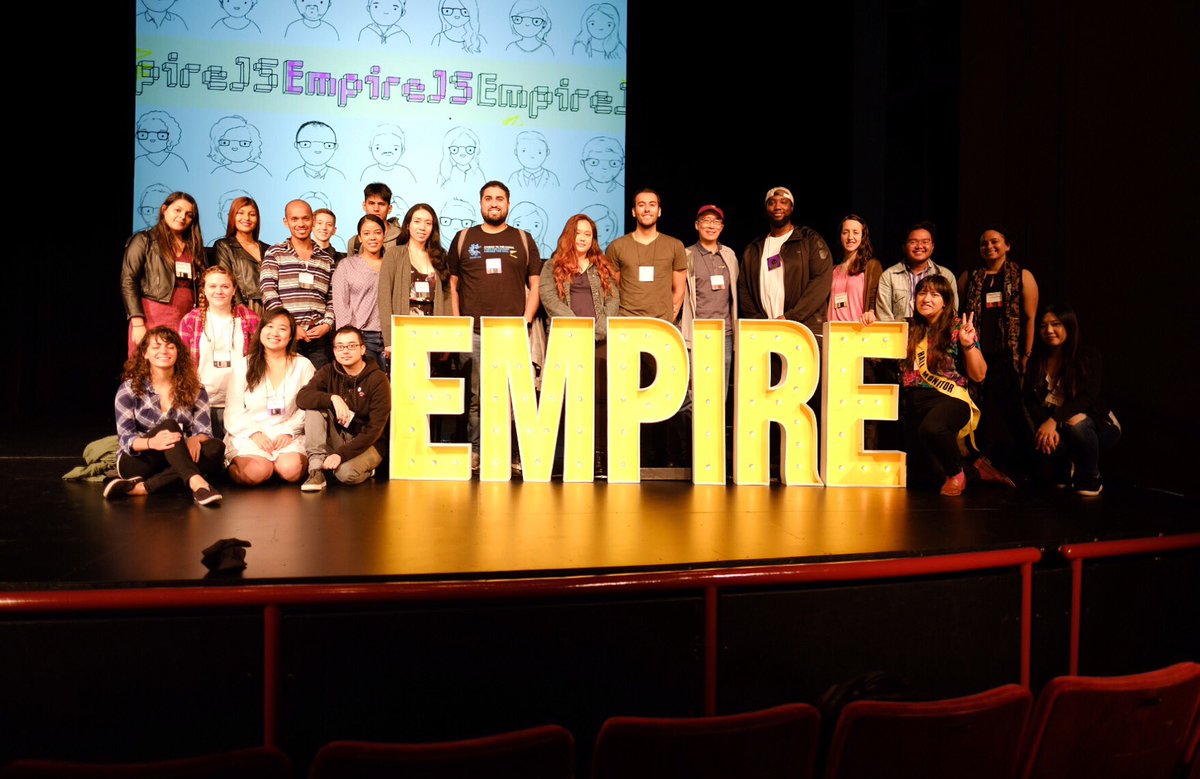 A group photo of the EmpireJS stage, featuring scholarship recipients standing around the Empire conference sign