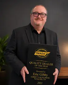 Eric Gibby holding his 2023 Tennessee Quality Dealer of the Year award