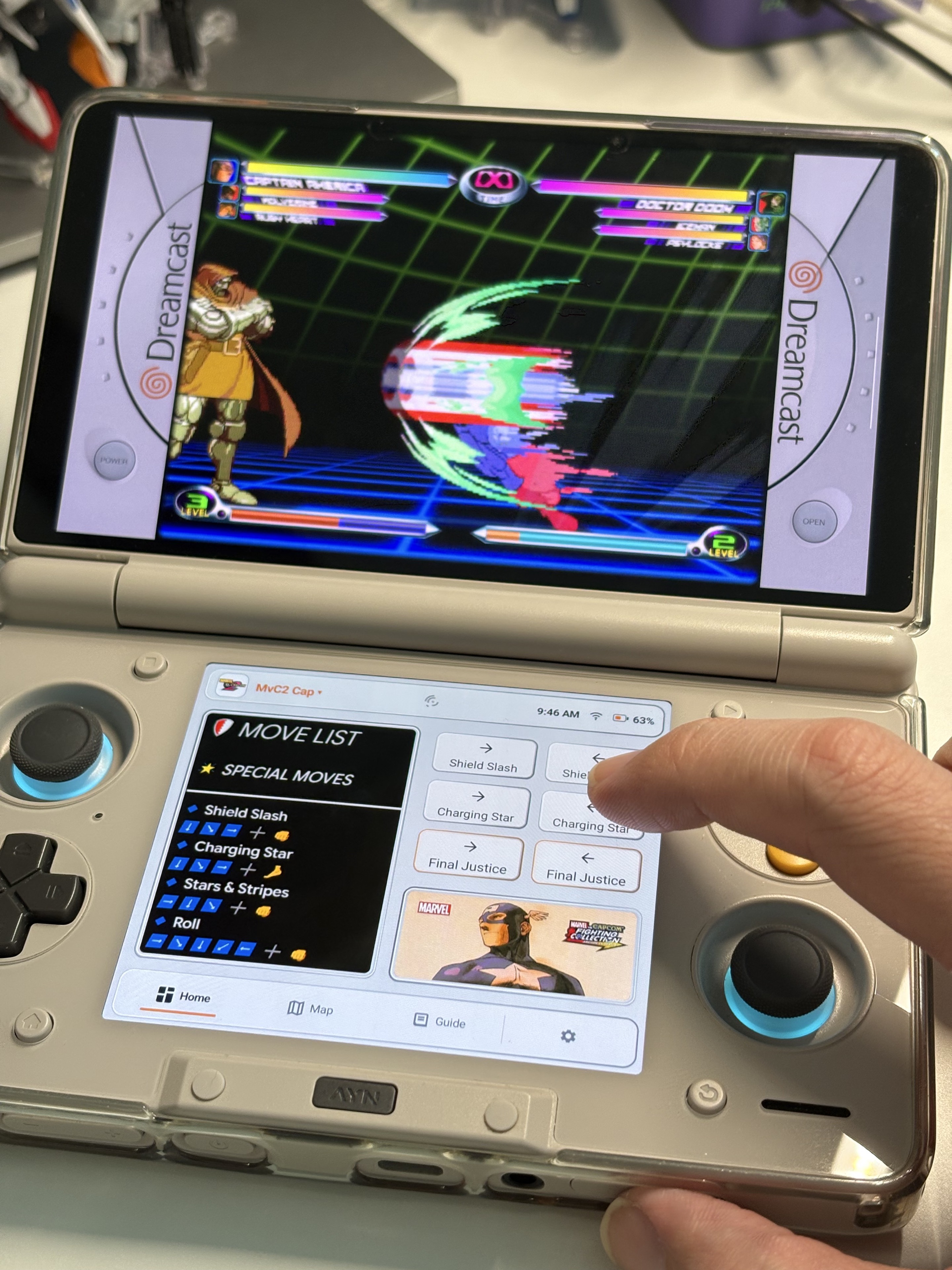 Player using Heimdall Canvas move-list reference and Macro buttons while a fighting game runs on the AYN Thor upper screen