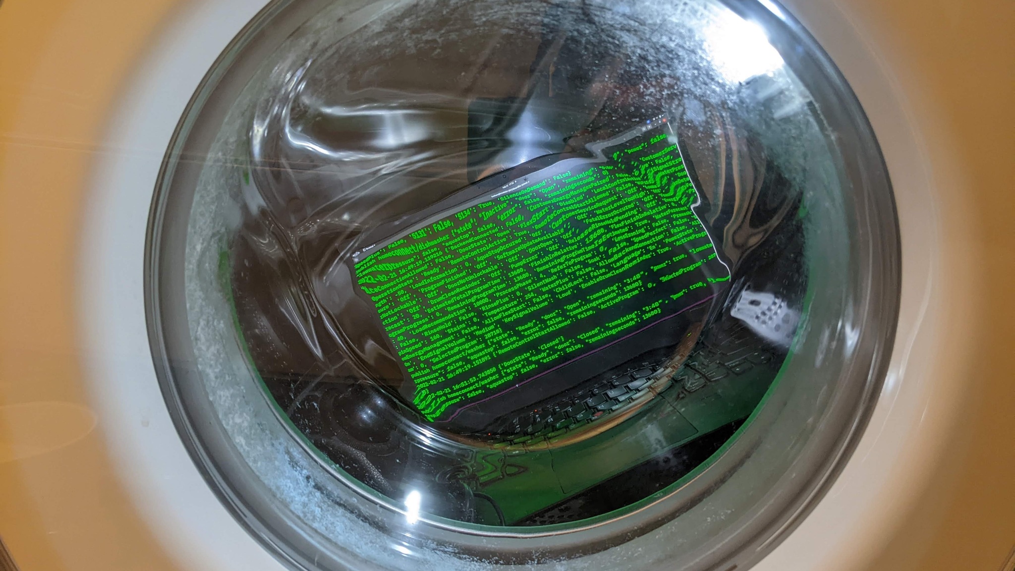 laptop in a clothes washer with a display DoorState:Closed