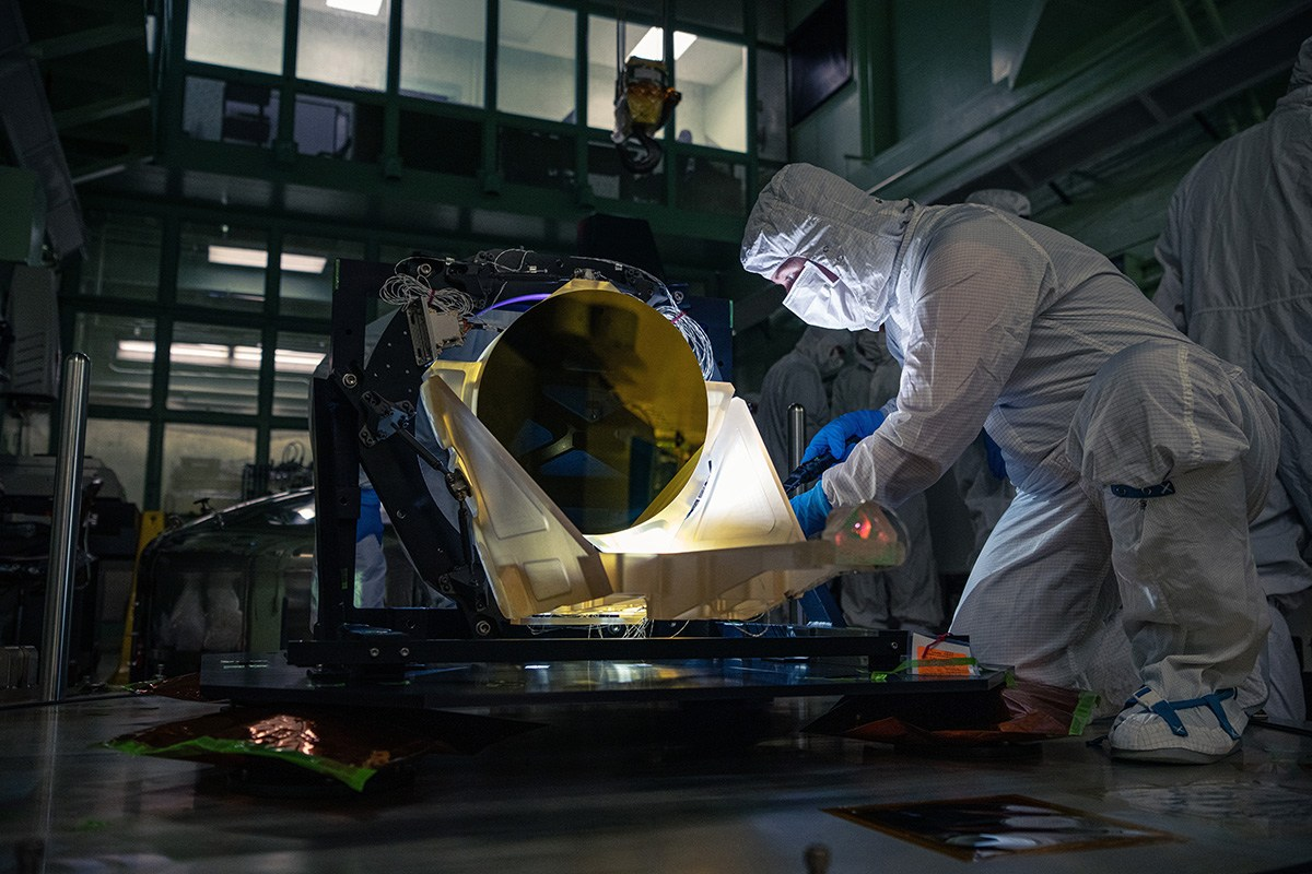 A LISA telescope prototype with a gold-colored mirror in a laboratory.