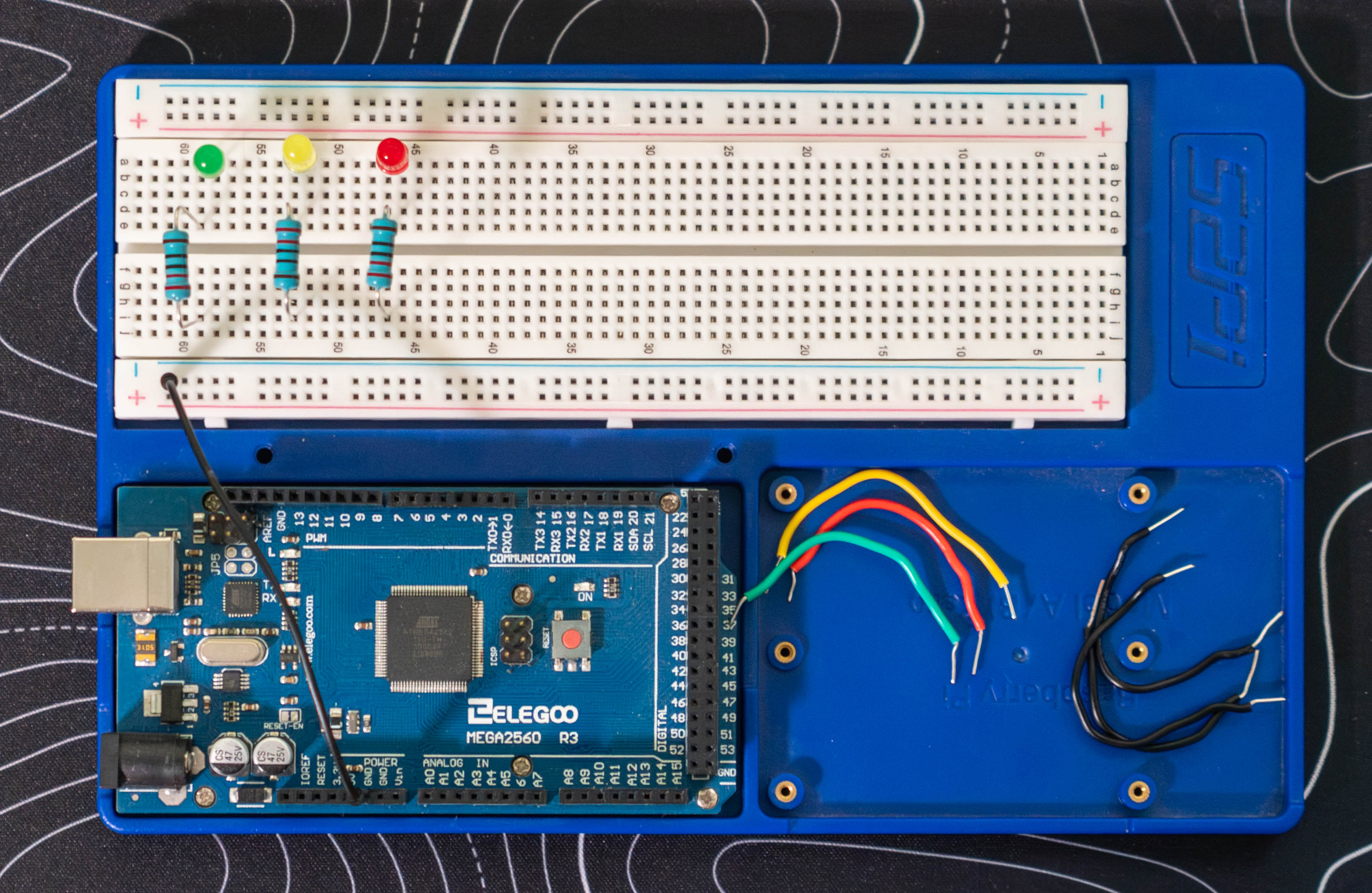 Arduino ground connected to breadboard ground rail, with 3 resistors and 3 LEDs wired in place