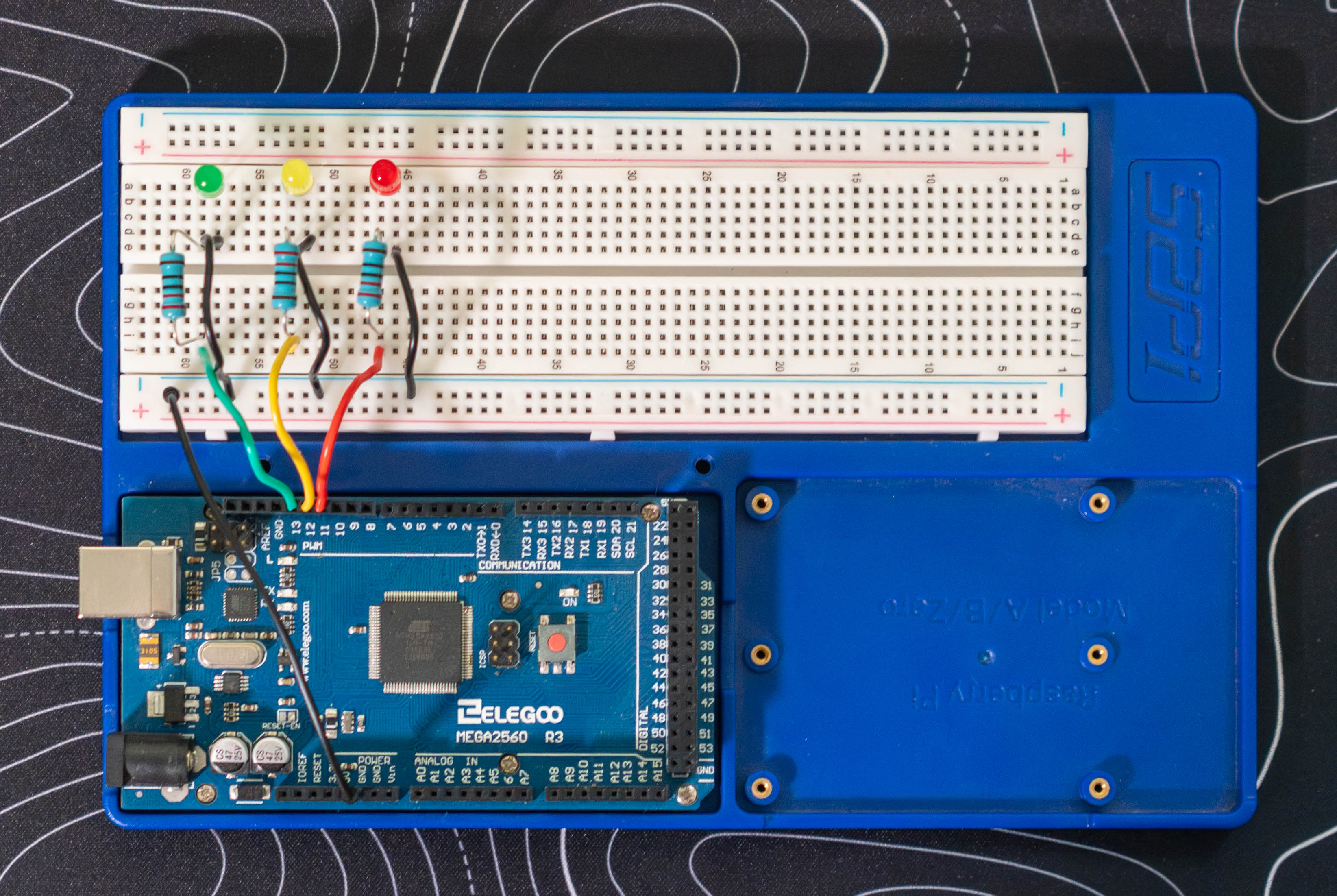 Ground wires added from each LED cathode to the breadboard ground rail, completing the circuit