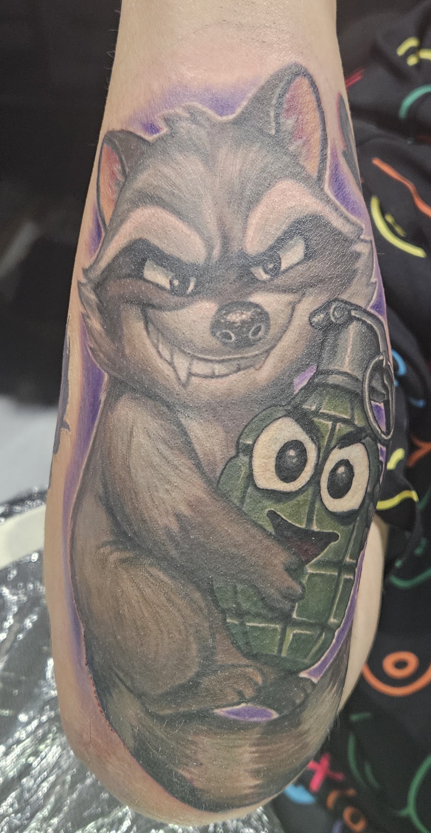 A raccoon holding a hand grenade tattoo