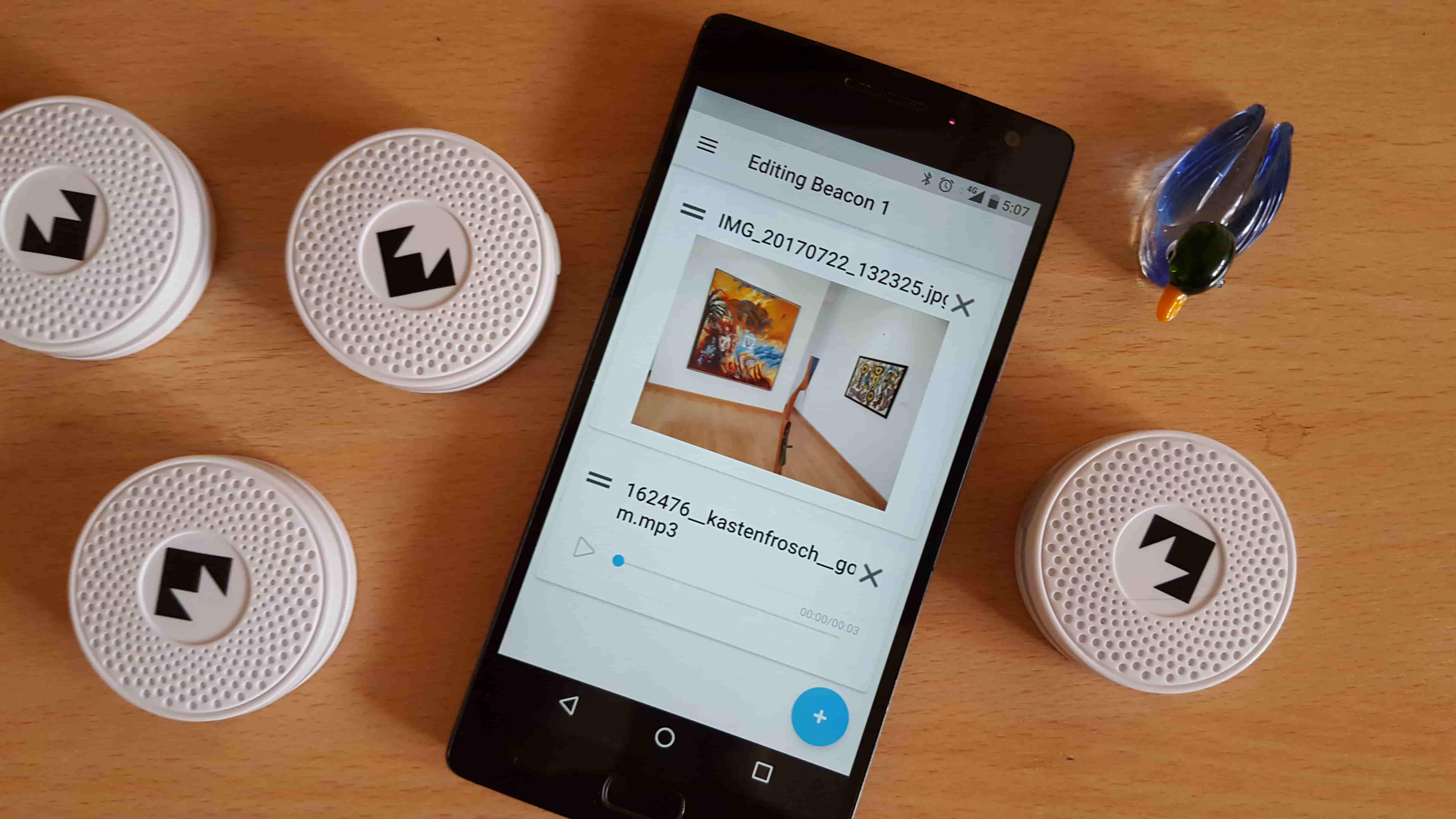 smartphone running the app, surrounded by Physical web beacons