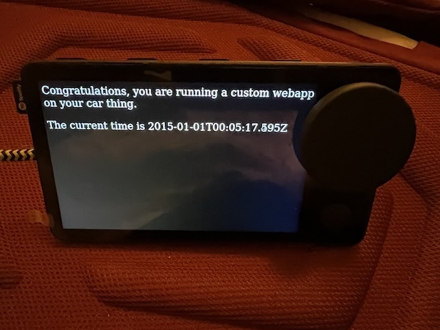 a spotify car thing showing the text "Congratulations, you are running a custom webapp on your car thing. The current time is 2015-01-01"