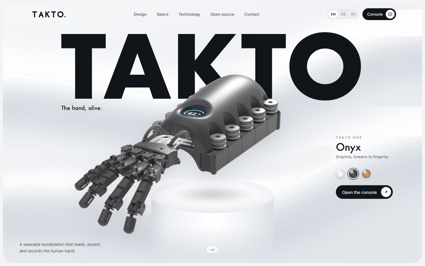takto.one: the TAKTO wordmark behind the graphite device floating over a white plinth