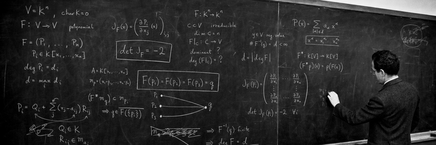 An archival-style black-and-white photograph of a mathematician working at a chalkboard, with a constant Jacobian determinant and three distinct inputs mapping to one output.
