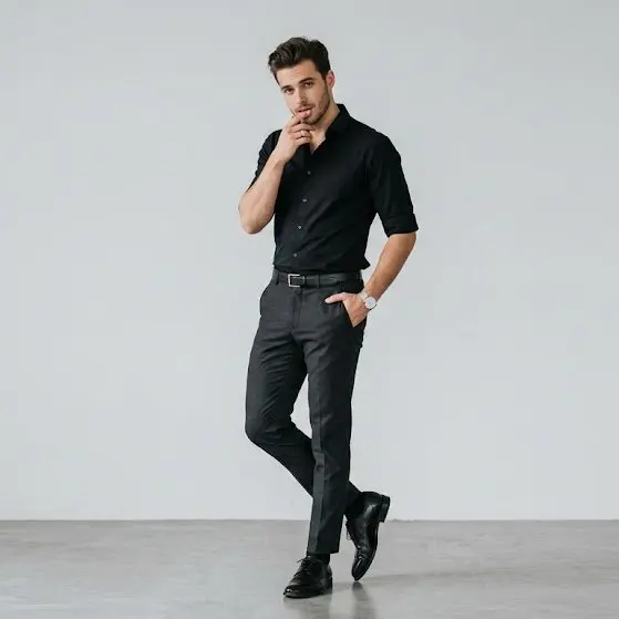 Full-body portrait of a stylish young man standing agains...