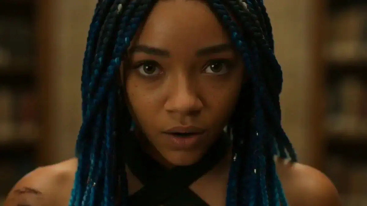 A 19-year-old woman with micro braids dyed deep indigo, w...