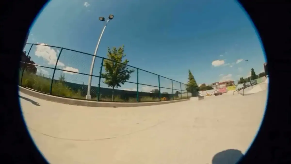 Fisheye lens skatepark shot on a sunny day with chain-lin...