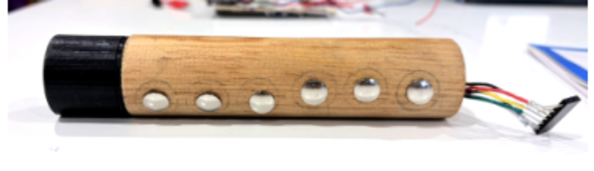 原论文 Figure 6:Detail of the capacitive touch sensors integrated into the carved wooden body.