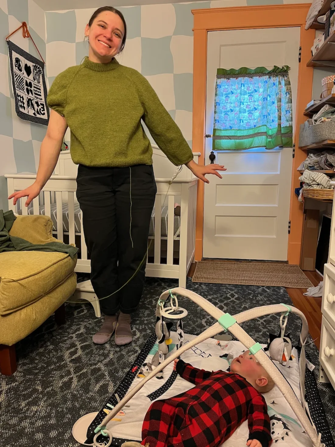 meg teaching a 6 month old child how to knit a sweater