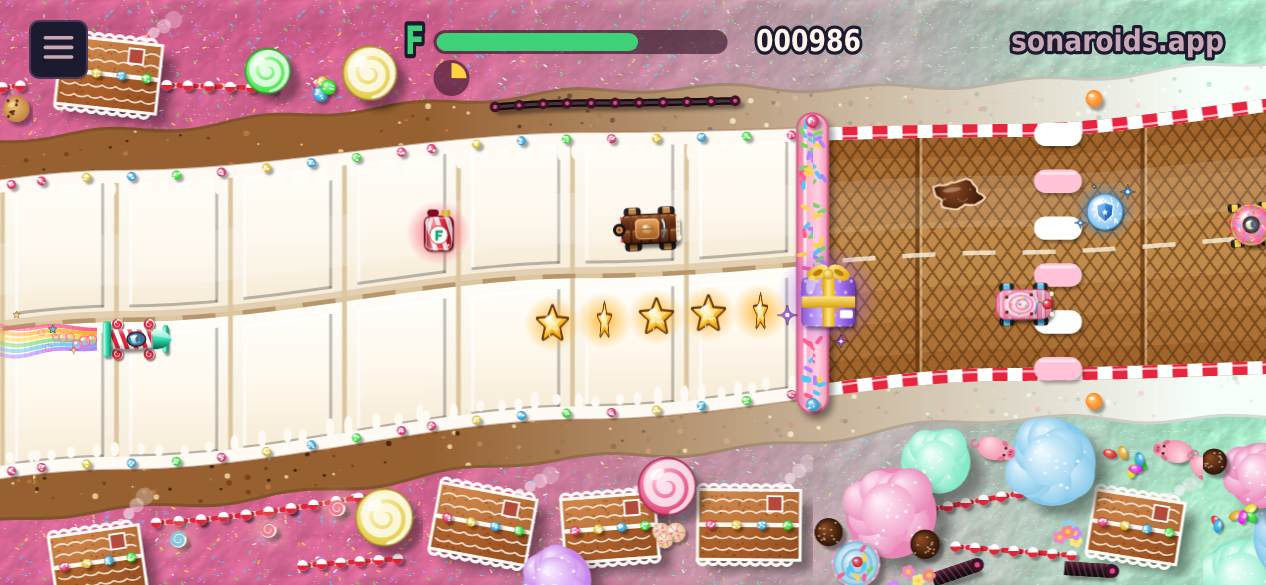 SonaRace in the candy land: a rocket car on a chocolate road, a soda bottle with an F, candy coins, a magnet, a shield bubble, the glowing super gift, other cars, a syrup puddle