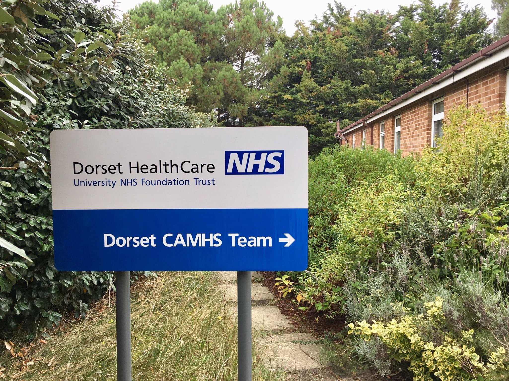 Picture of Dorset CAMHS sign in a leafy setting