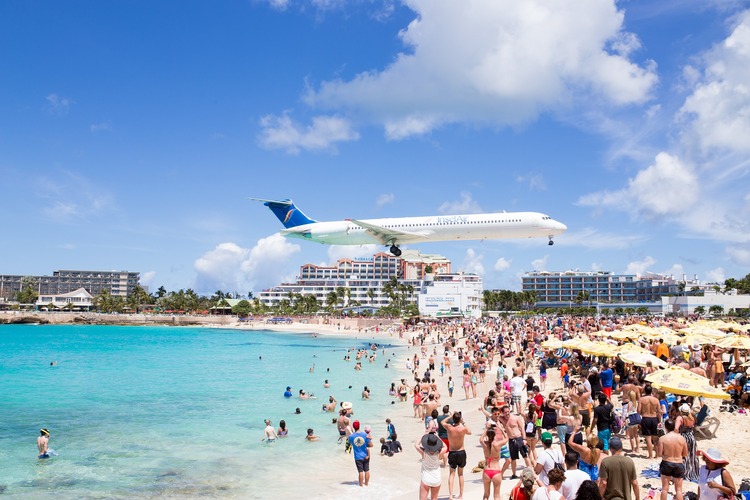 plane landing above beach