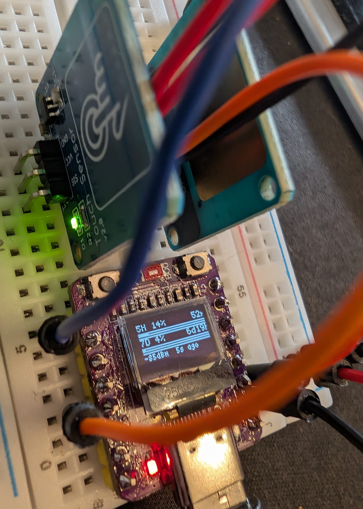 ESP32-C3-OLED wired with capacitive touch sensors on GPIO 3 and GPIO 7