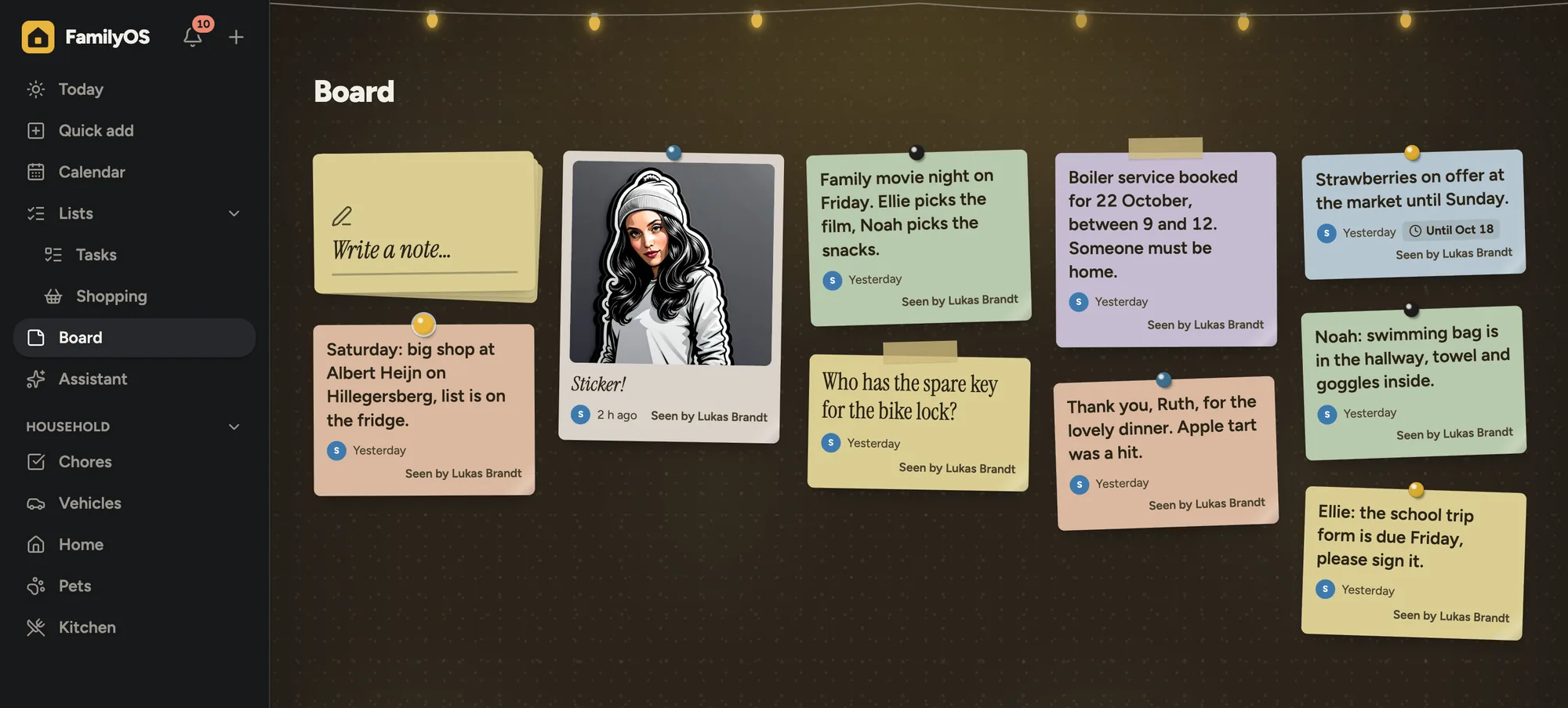 The family board: notes on cork with pins and tape under a string of lights
