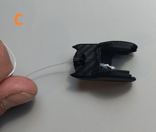 Step C: pulling the PTFE tube into the channel by the tendon
