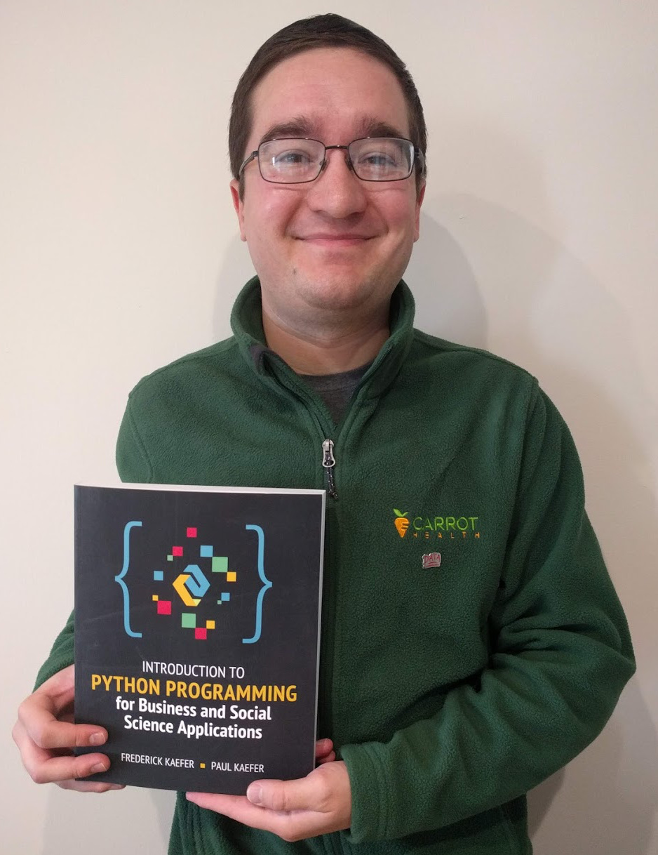 Photo of me with the textbook I co-authored.