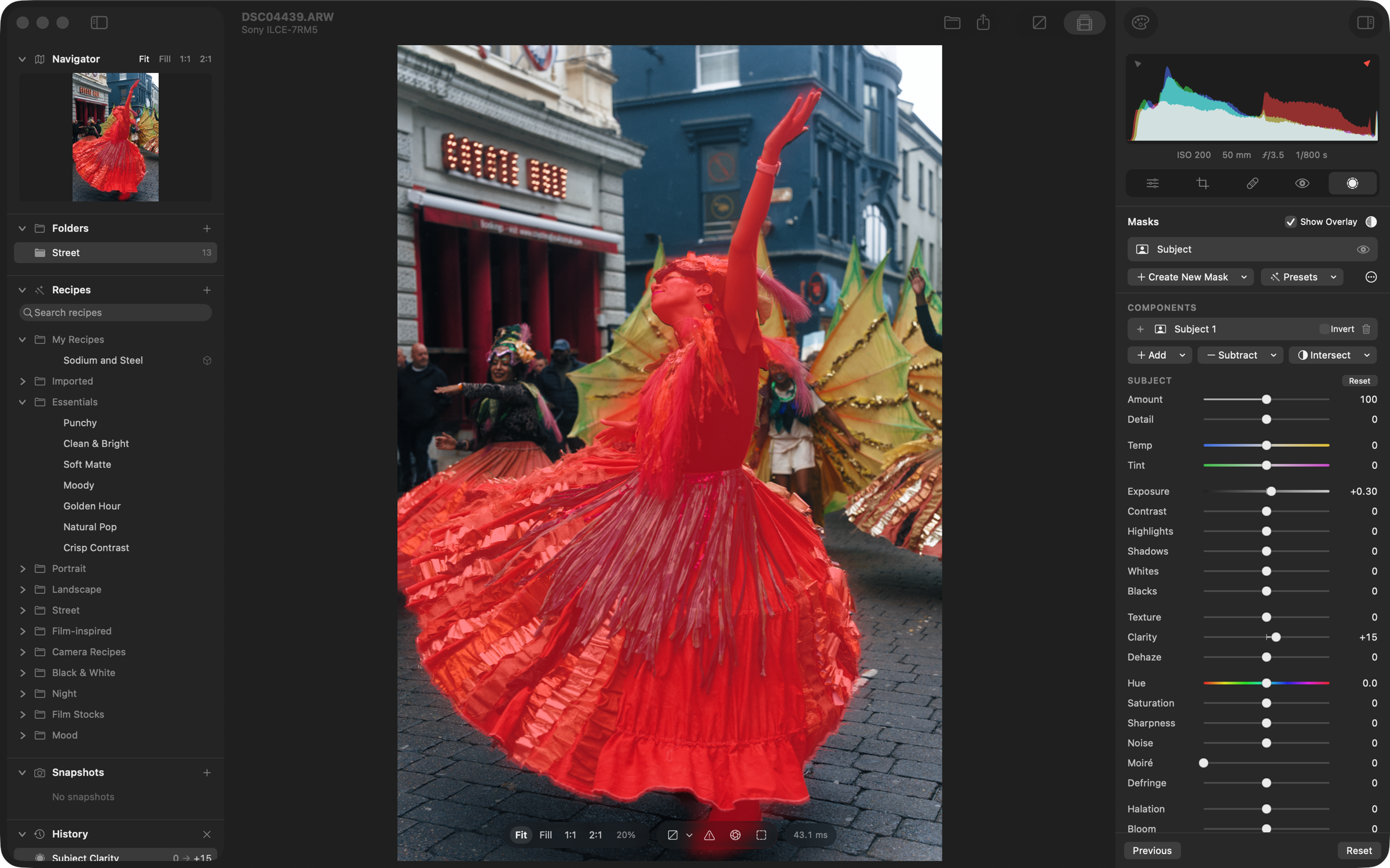 The dancer selected by a Subject mask, shown in the red mask overlay, with the mask's Exposure and Clarity raised in the Masks panel on the right