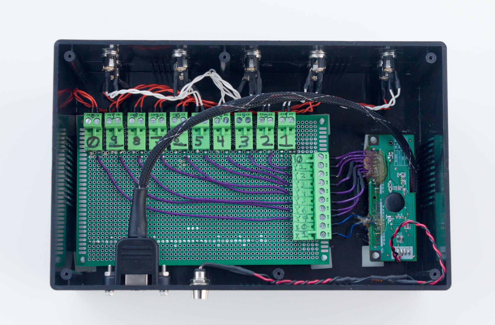 Photo of the inside of the black plastic box showing two circuit boards and a bunch of wires and connectors