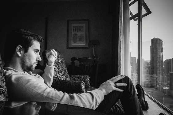 man looking out over a city from a room