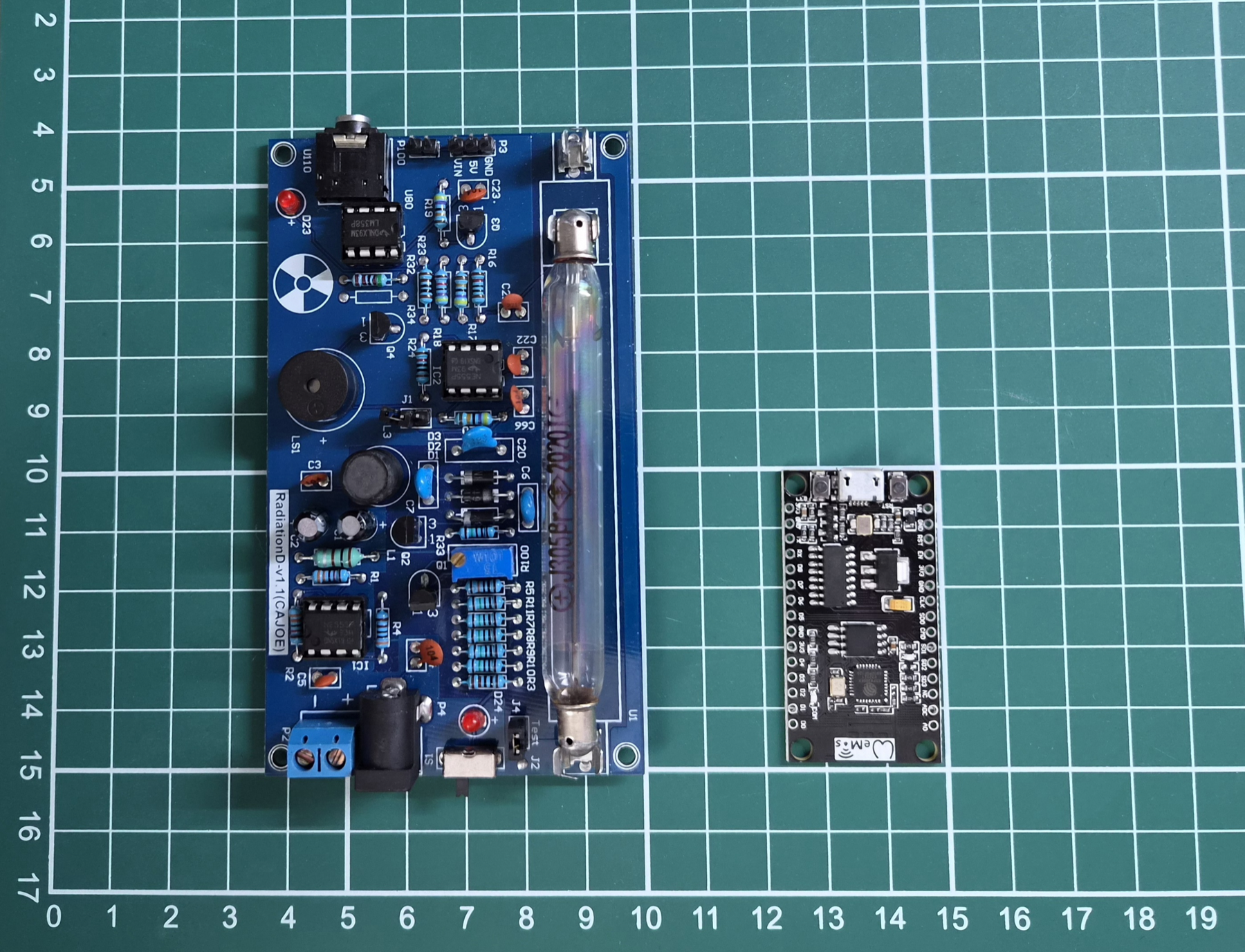RadiationD-v1.1 Geiger counter board and ESP8266 development board on a measurement grid