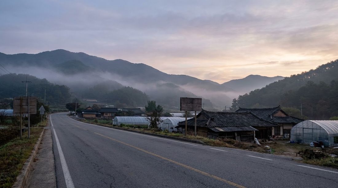 An empty rural road at dawn in the Korean countryside