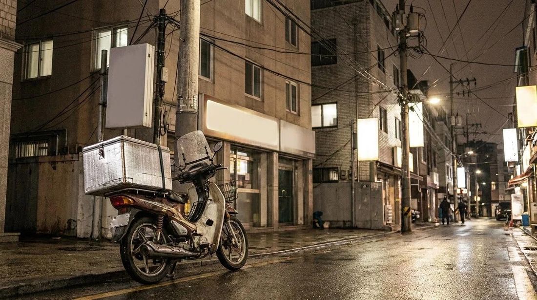 A delivery motorbike parked on a night street