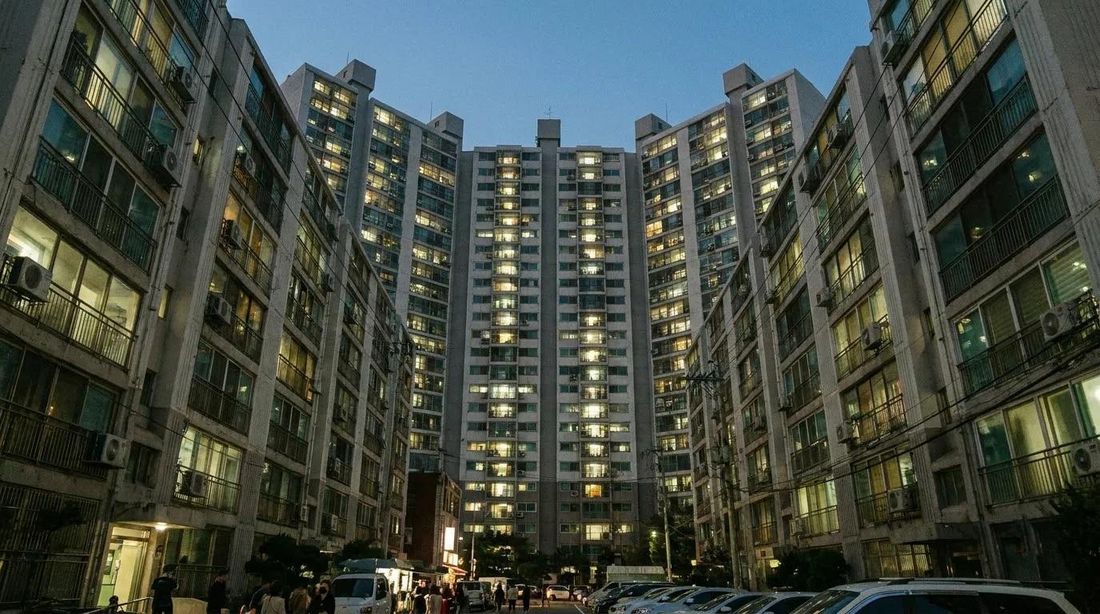 Apartment towers seen from below at dusk