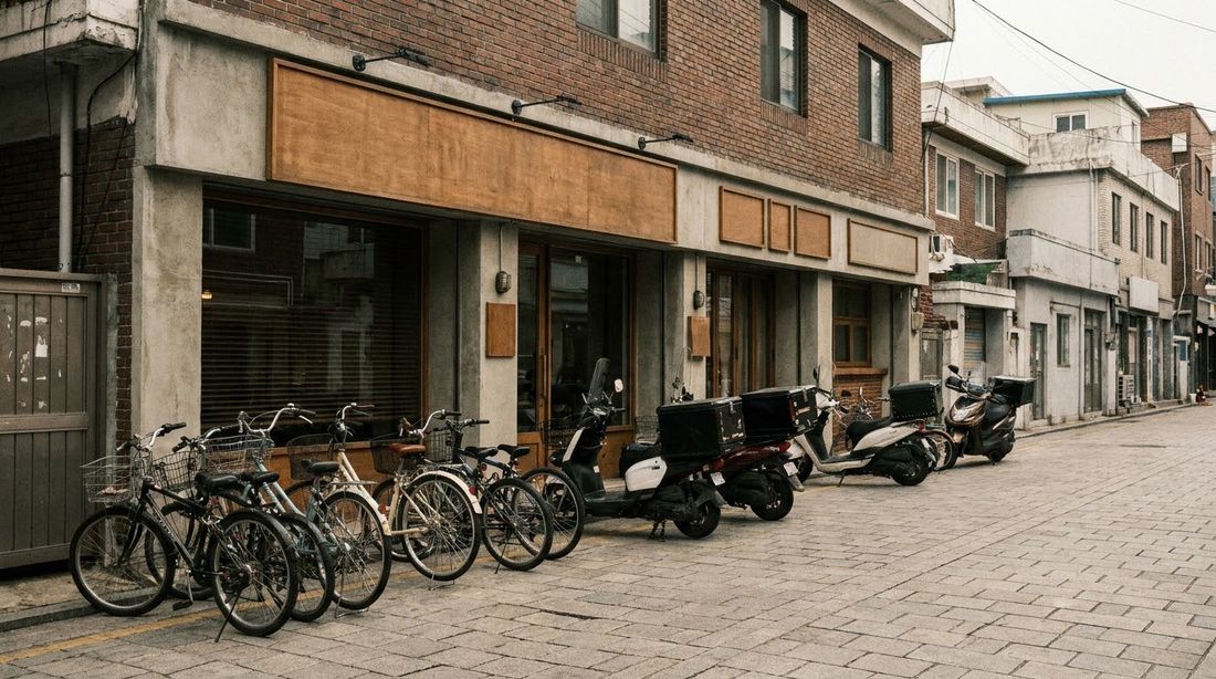 Bicycles and delivery scooters left unattended outside a Korean shopfront