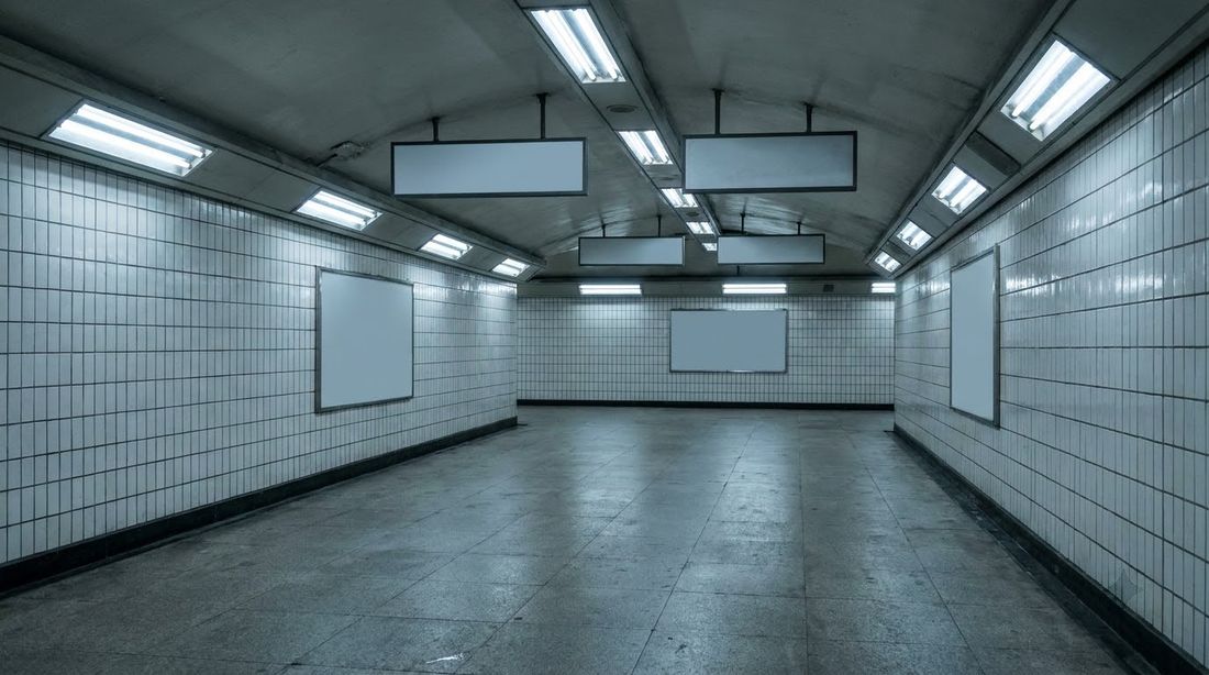An empty tiled pedestrian underpass in Seoul at night