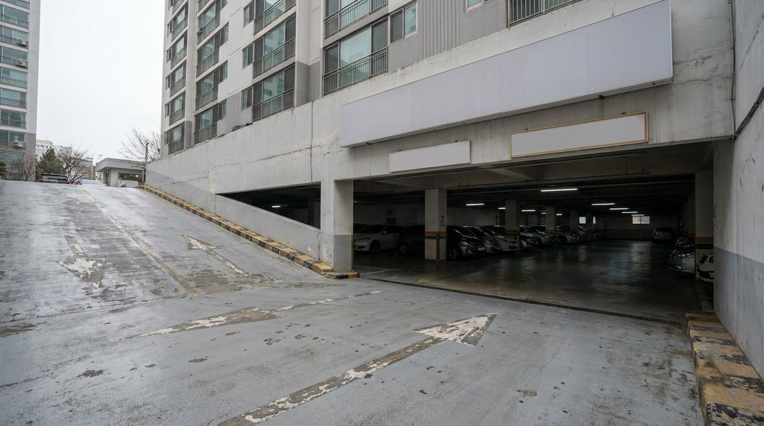 The ramp down into the underground garage beneath a Korean apartment tower