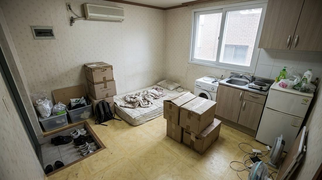 A small Seoul studio apartment with moving boxes on the floor