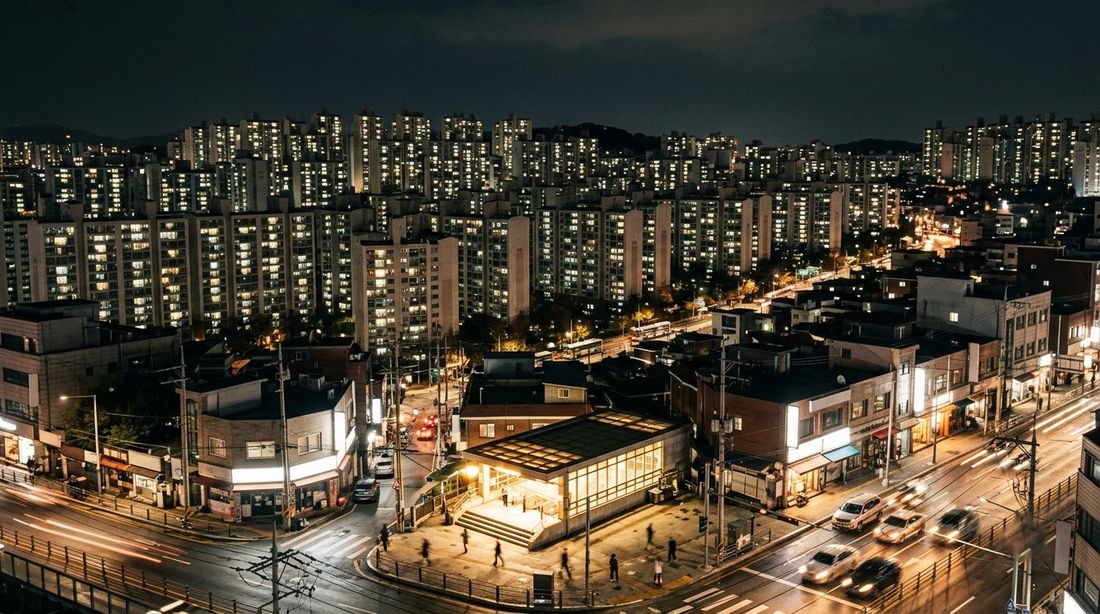 밤에 불이 켜진 한국 도시의 아파트와 상가