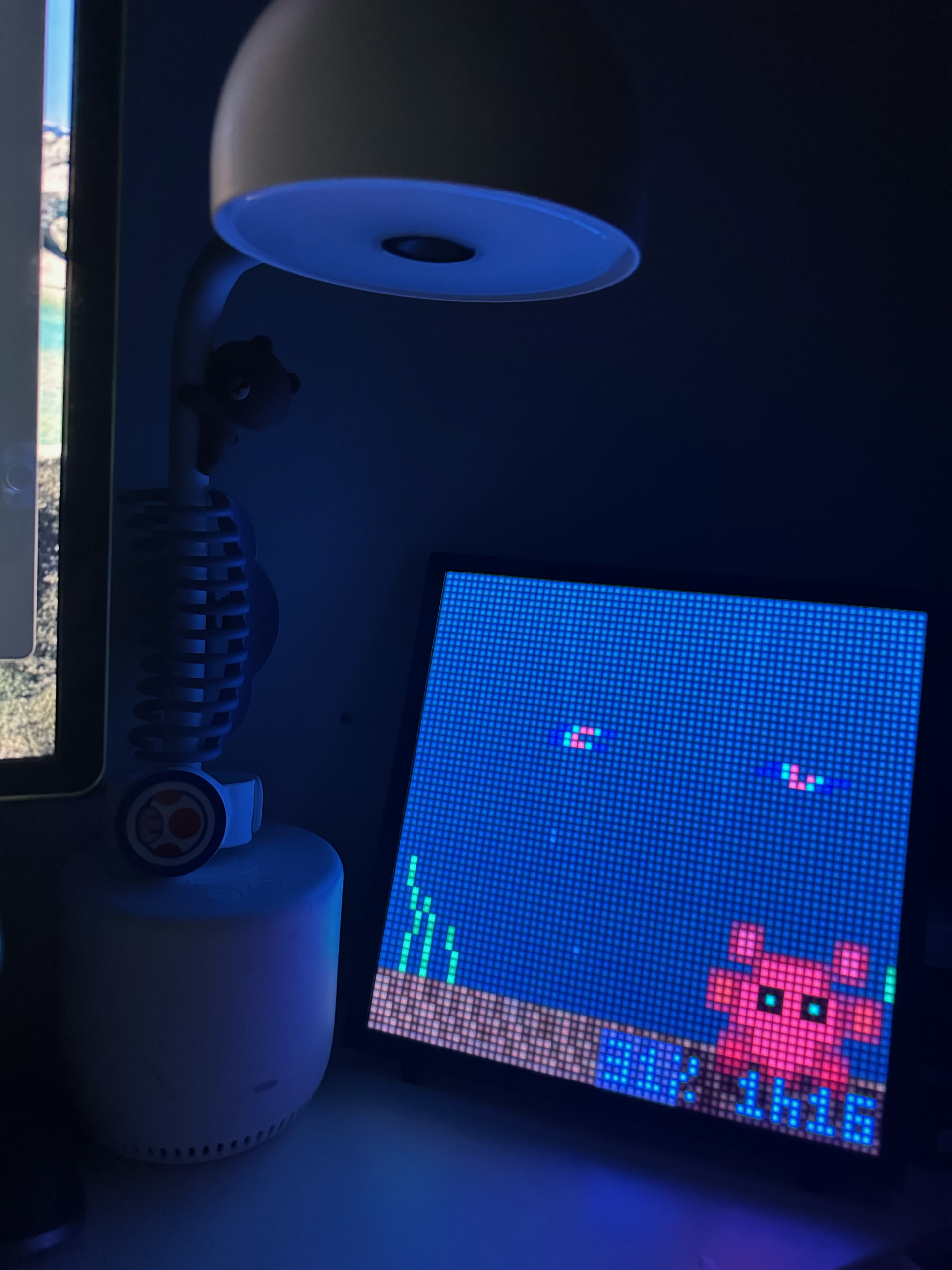 Pixoo64 LED matrix — pixel art octopus and crayfish glowing in the dark