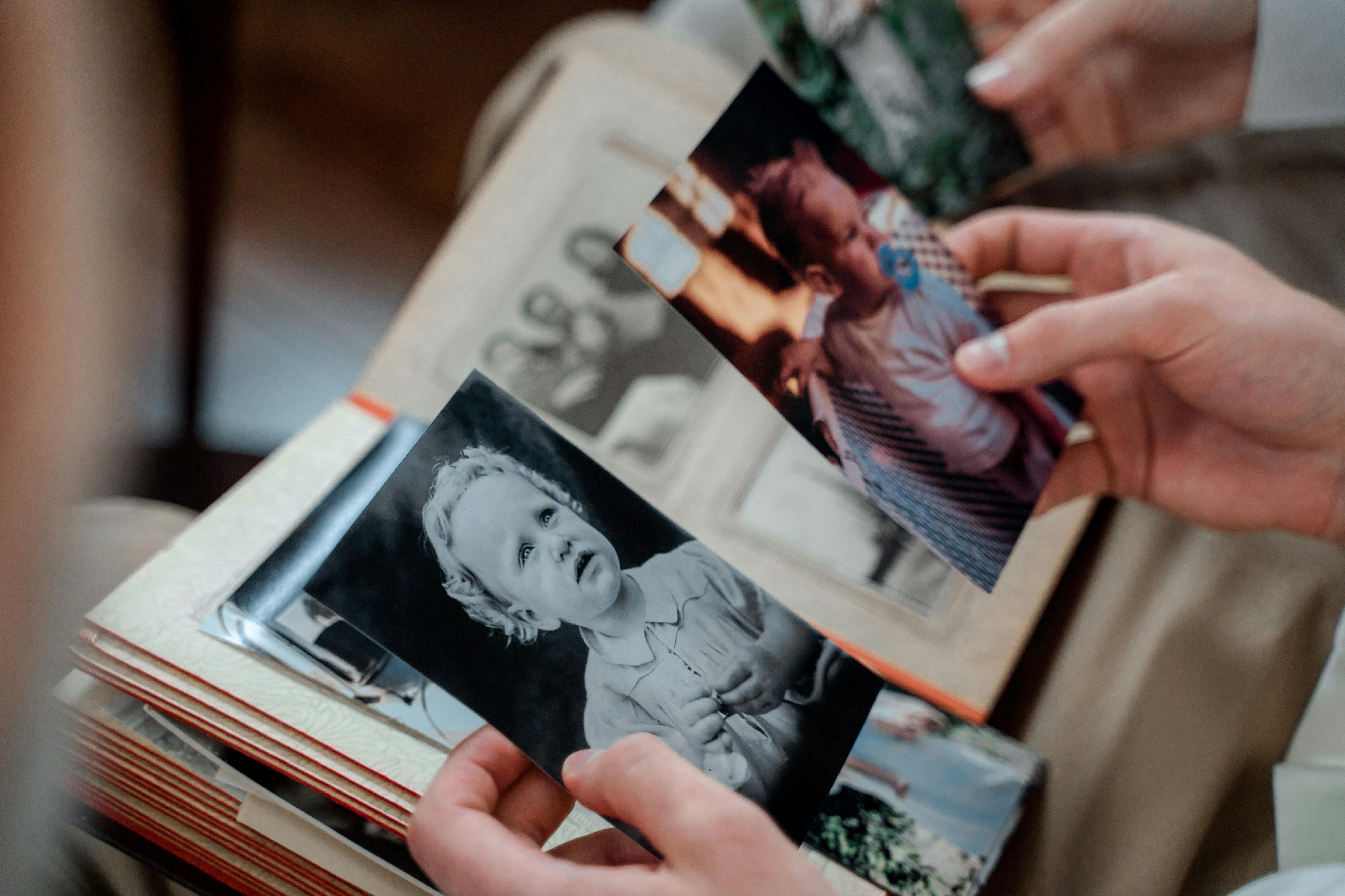 Hands holding old family photographs