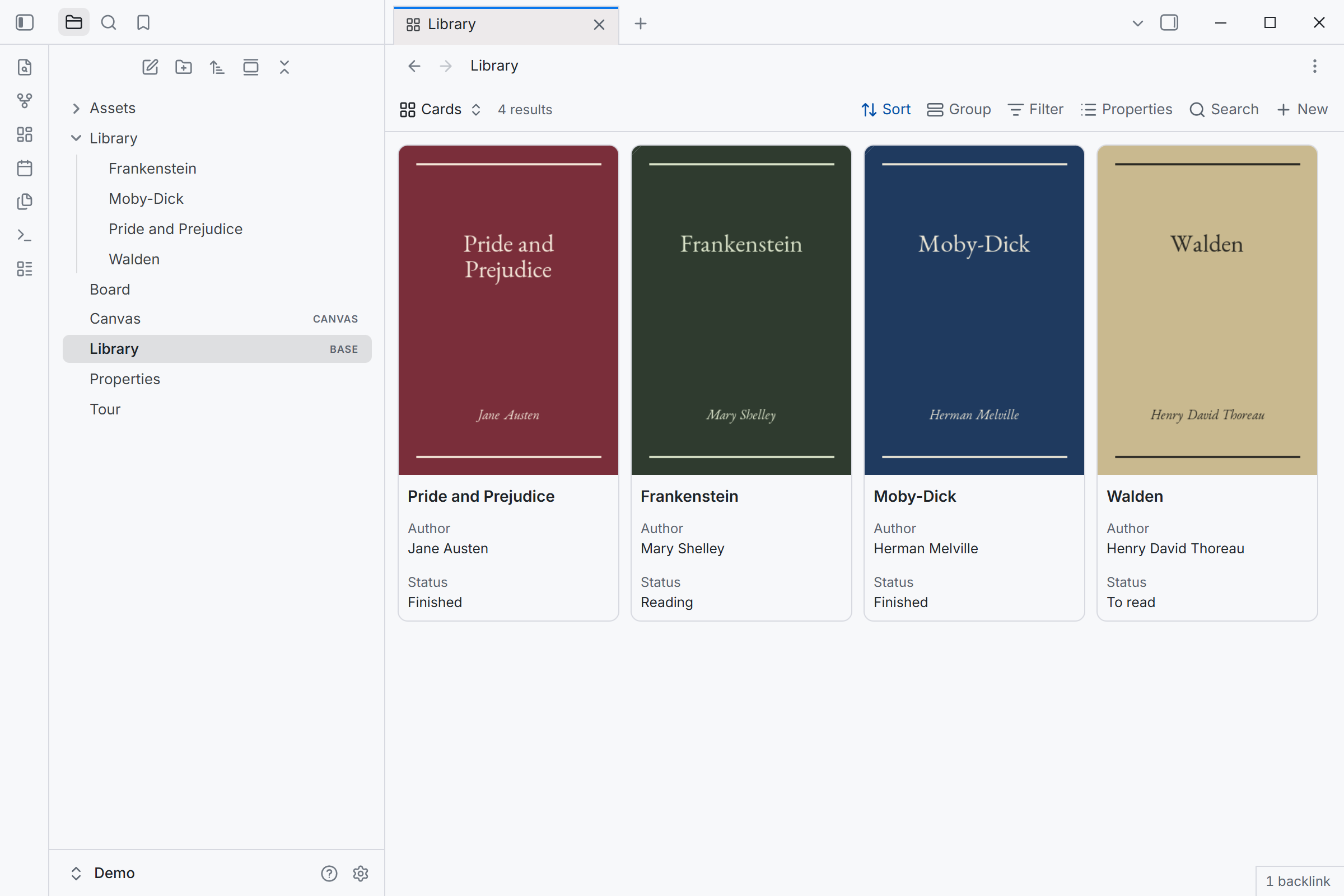 A base in cards view, showing four book covers, in light mode