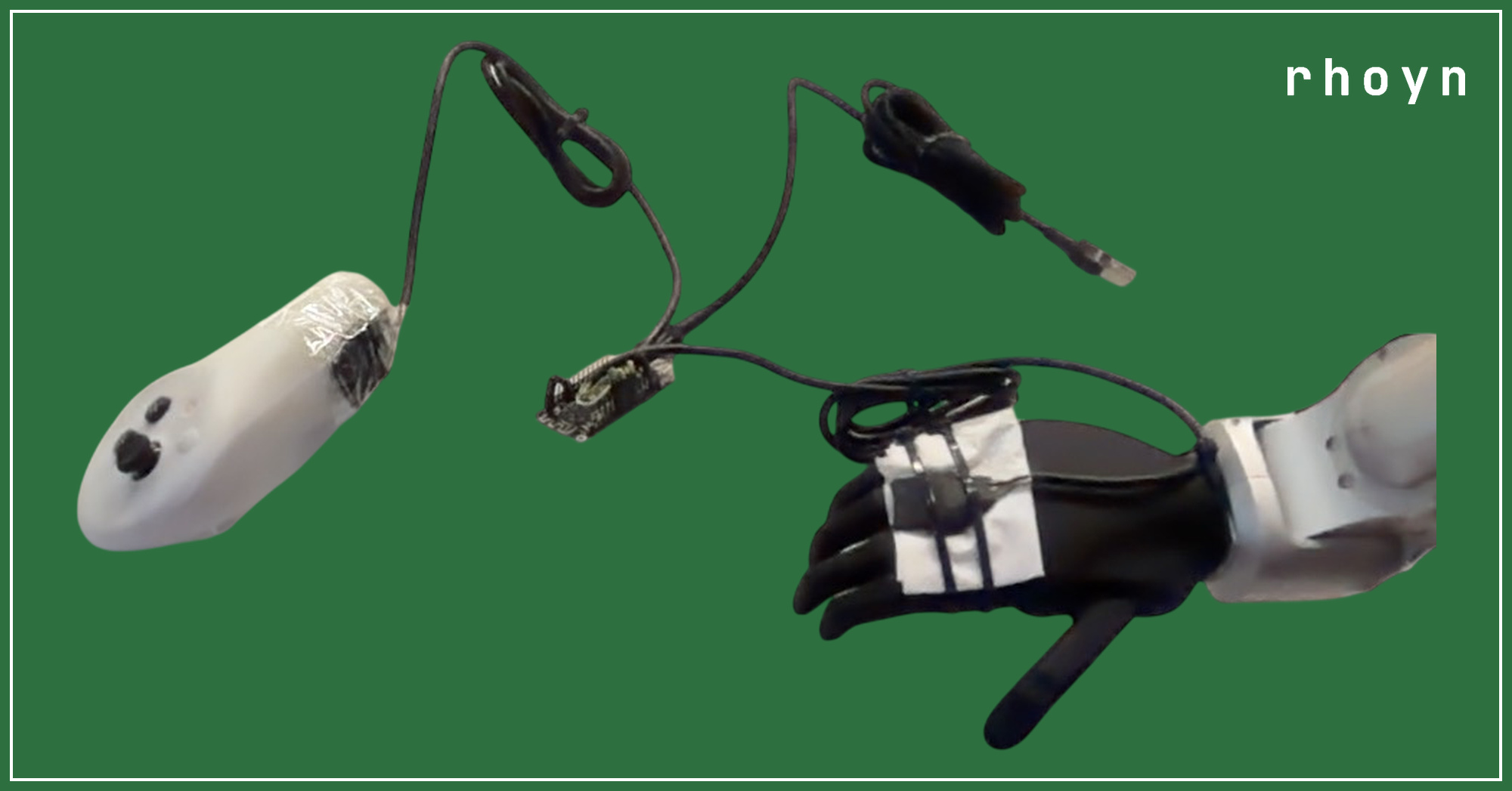 The rig as built: an MPU6050 taped inside the operator's hand controller on the left, another taped to the robot's black gloved hand on the right, both cabled to the small ESP32 board between them, with the USB lead running off to the laptop